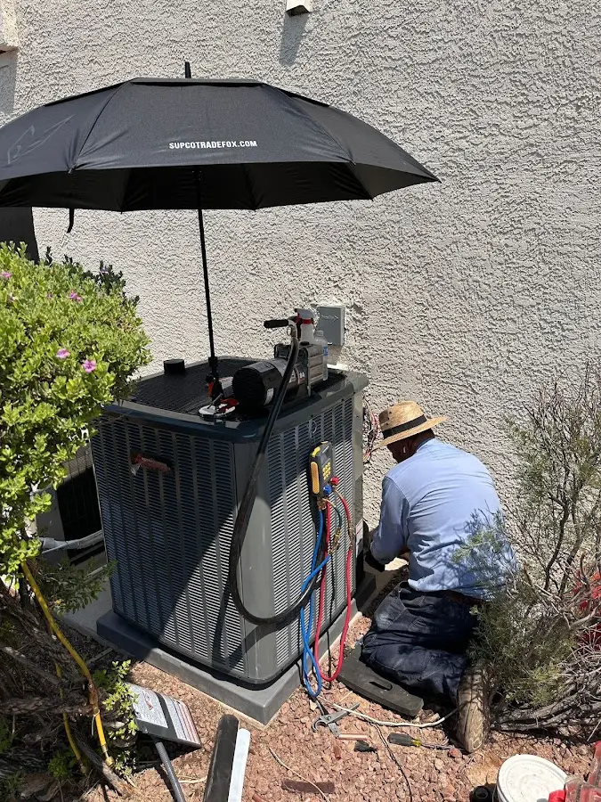 HVAC technician performing outdoor AC maintenance in Clanton