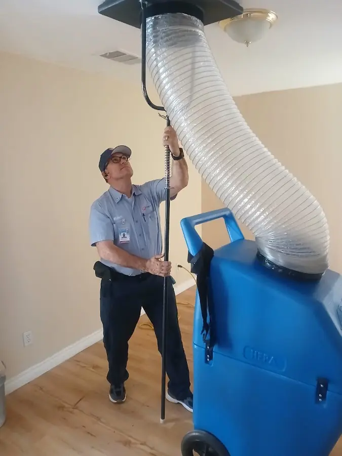 Furnace Tune-Up technician using HEPA equipment in Clanton
